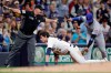 Milwaukee Brewers' Christian Yelich (22) slides safely into third base past the tag of New York Mets' Jonathan Villar, right, for a triple during the fifth inning of a baseball game Friday, Sept. 24, 2021, in Milwaukee. (AP Photo/Aaron Gash)