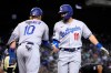 Los Angeles Dodgers' AJ Pollock celebrates with Justin Turner (10) after hitting a two-run home run against the Arizona Diamondbacks in the second inning during a baseball game, Friday, Sept. 24, 2021, in Phoenix. (AP Photo/Rick Scuteri)