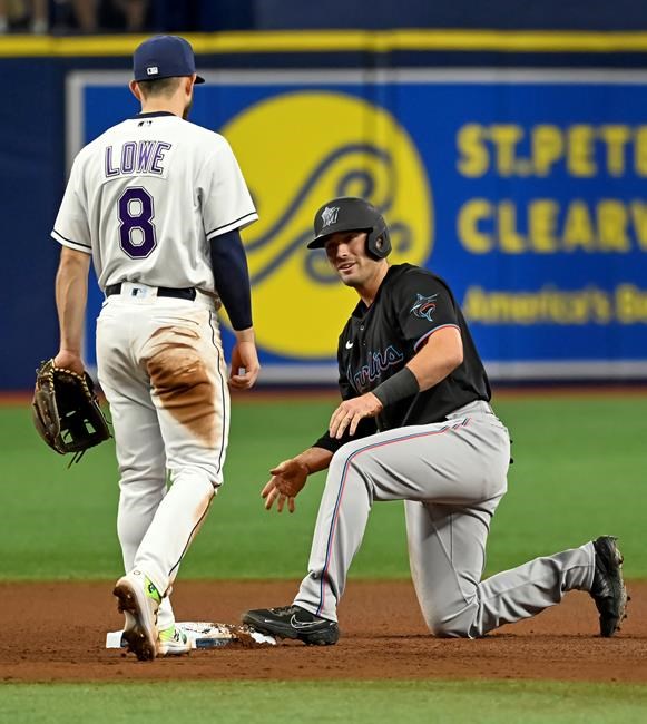 Miami Marlins' Nick Fortes, right, looks at Tampa Bay Rays infielder Brandon Lowe (8) after he stole second base during the fourth inning of a baseball game Saturday, Sept. 25, 2021, in St. Petersburg, Fla. (AP Photo/Steve Nesius)