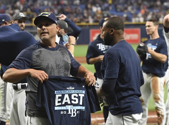 Tampa Bay Rays manager Kevin Cash celebrates after defeating the Miami Marlins to clinch the American League East in a baseball game Saturday, Sept. 25, 2021, in St. Petersburg, Fla. (AP Photo/Steve Nesius)