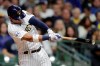 Milwaukee Brewers' Eduardo Escobar hits a two-run single during the third inning of a baseball game against the New York Mets Saturday, Sept. 25, 2021, in Milwaukee. (AP Photo/Aaron Gash)
