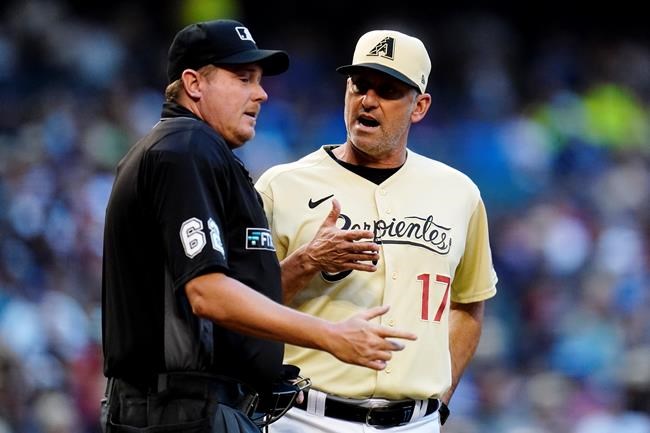 Arizona Diamondbacks manager Torey Lovullo (17) argues with umpire Chad Whitson, left, during the third inning of a baseball game against the Los Angeles Dodgers Saturday, Sept. 25, 2021, in Phoenix. (AP Photo/Ross D. Franklin)
