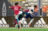 Vancouver Whitecaps' Brian White, front right, scores against FC Dallas goalkeeper Jimmy Maurer, back, as Justin Che defends during the first half of an MLS soccer game in Vancouver, on Saturday, September 25, 2021. THE CANADIAN PRESS/Darryl Dyck