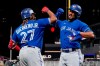 Toronto Blue Jays Marcus Semien, right, celebrates his solo home run off Minnesota Twins pitcher Bailey Ober with Vladimir Guerrero Jr. in the sixth inning of a baseball game, Friday, Sept. 24, 2021, in Minneapolis. THE CANADIAN PRESS/AP, Jim Mone
