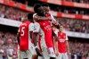 Arsenal's Bukayo Saka, center, celebrates after scoring his side's third goal during the English Premier League soccer match between Arsenal and Tottenham Hotspur at the Emirates stadium in London, Sunday, Sept. 26, 2021. (AP Photo/Frank Augstein)