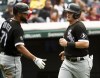 Chicago White Sox's Jose Abreu greets Andrew Vaughn after Vaughn scored on a single by Leury Garcia during the sixth inning of a baseball game in Cleveland, Sunday, Sept. 26, 2021. (AP Photo/Phil Long)