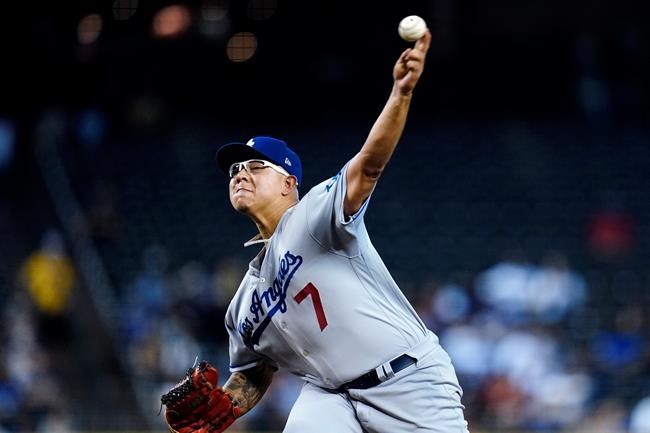 Los Angeles Dodgers starting pitcher Julio Urias throws against the Arizona Diamondbacks during the first inning of a baseball game Sunday, Sept. 26, 2021, in Phoenix. (AP Photo/Ross D. Franklin)