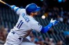 Los Angeles Dodgers' AJ Pollock fouls a ball off his face during the first inning of a baseball game against the Arizona Diamondbacks Sunday, Sept. 26, 2021, in Phoenix. (AP Photo/Ross D. Franklin)