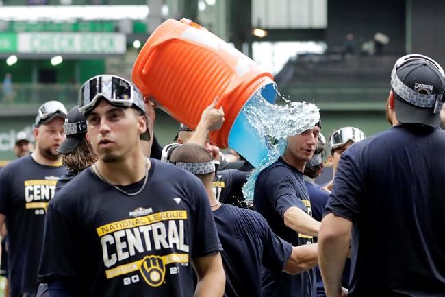 Milwaukee Brewers manager Craig Counsell is doused after a baseball game against the New York Mets, Sunday, Sept. 26, 2021, in Milwaukee. The Brewers clinched the National League Central Division. (AP Photo/Aaron Gash)