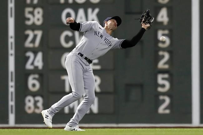 New York Yankees' Joey Gallo misses the catch on a fly ball hit by Boston Red Sox's Kyle Schwarber allowing Alex Verdugo to score during the seventh inning of a baseball game, Sunday, Sept. 26, 2021, in Boston. (AP Photo/Michael Dwyer)