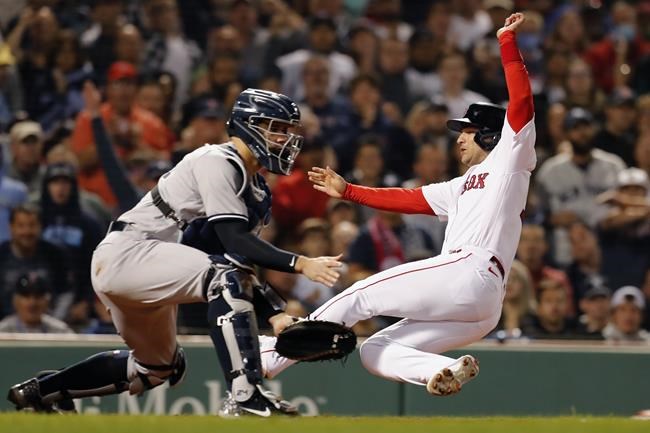 CORRECTS FROM CHRISTIAN ARROYO TO CHRISTIAN VAZQUEZ - Boston Red Sox's Jose Iglesias, right, scores ahead of the throw to New York Yankees' Gary Sanchez on a sacrifice fly by Christian Vazquez during the seventh inning of a baseball game, Sunday, Sept. 26, 2021, in Boston. (AP Photo/Michael Dwyer)