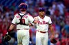 Philadelphia Phillies starting pitcher Ranger Suarez, right, is congratulated by J.T. Realmuto after their victory over the Pittsburgh Pirates, Saturday, Sept. 25, 2021, in Philadelphia. (AP Photo/Derik Hamilton)