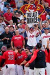A Cleveland Indians fan holds up a sign as the team celebrates after defeating the Kansas City Royals in a baseball game, Monday, Sept. 27, 2021, in Cleveland. Cleveland played its final home game against the Royals as the Indians, the team's nickname since 1915. The club will be called the Cleveland Guardians next season. (AP Photo/Tony Dejak)