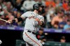 San Francisco Giants' Brandon Belt follows the flight of his single off Colorado Rockies relief pitcher Daniel Bard in the seventh inning of a baseball game Saturday, Sept. 25, 2021, in Denver. (AP Photo/David Zalubowski)