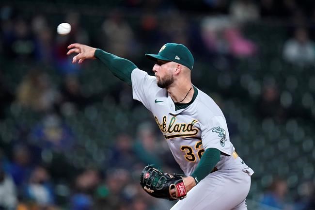 Oakland Athletics relief pitcher James Kaprielian throws against the Seattle Mariners in the fifth inning of a baseball game Monday, Sept. 27, 2021, in Seattle. (AP Photo/Elaine Thompson)