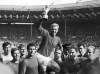 FILE - IIn this July 30, 1966 file photo England's soccer team captain Bobby Moore, is carried shoulder high by his teammates holding World Cup on July 30, 1966. England defeated West Germany 4-2 in the final, played at London's Wembley Stadium. From left to right, goalkeeper Gordon Banks, Alan Ball, Roger Hunt, Geoff Hurst, Moore, Ray Wilson, George Cohen and Bobby Charlton. Roger Hunt, a striker in the only England team to win the World Cup and one of Liverpool's most prolific scorers, has died. He was 83. Liverpool, where Hunt spent most of his playing career, said he died on Monday Sept. 27, 2021, after a long illness. (AP Photo/Bippa, File)