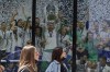 FILE - In this Monday, April 19, 2021 file photo, two women walk past a Real Madrid poster of the team celebrating in a merchandising shop in Madrid, Spain. UEFA on Tuesday Sept. 28, 2021, took legal action to remove the judge from a Spanish court case thwarting the attempt to punish Barcelona, Real Madrid and Juventus for their involvement in the ill-fated Super League breakaway. (AP Photo/Paul White, File)