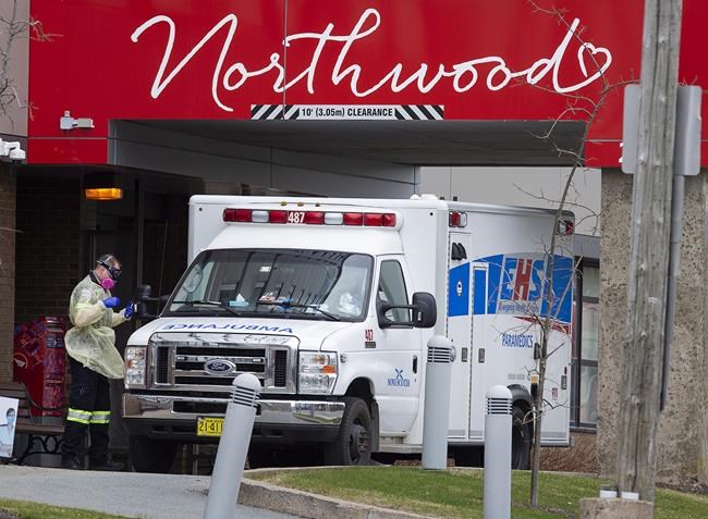 A paramedic walks around an ambulance at Northwood Manor, one of the largest nursing homes in Atlantic Canada with 585 residents, in Halifax on Friday, May 1, 2020. THE CANADIAN PRESS/Andrew Vaughan