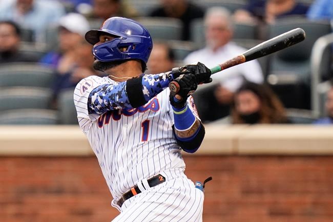 New York Mets' Jonathan Villar (1) hits an RBI single during the third inning in the first baseball game of a doubleheader against the Miami Marlins, Tuesday, Sept. 28, 2021, in New York. (AP Photo/Frank Franklin II)