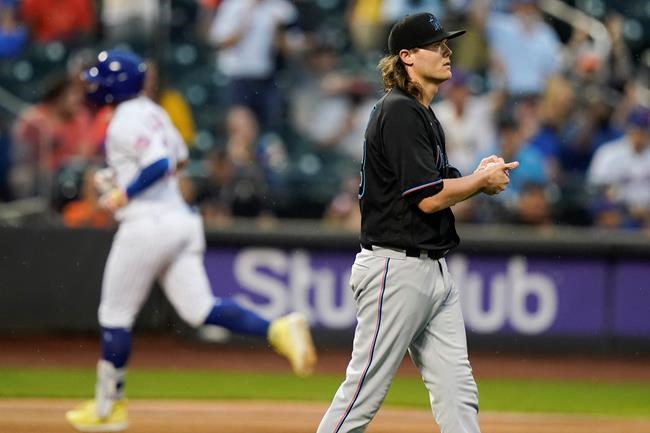 Miami Marlins relief pitcher Steven Okert, right, reacts as New York Mets' Francisco Lindor (12) runs the bases after hitting a two-run home run during the sixth inning in the first baseball game of a doubleheader Tuesday, Sept. 28, 2021, in New York. The Mets won 5-2. (AP Photo/Frank Franklin II)