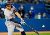 New York Yankees' Giancarlo Stanton (27) hits a three-run home run during seventh inning American League MLB baseball action against the Toronto Blue Jays in Toronto on Tuesday, September 28, 2021. THE CANADIAN PRESS/Frank Gunn