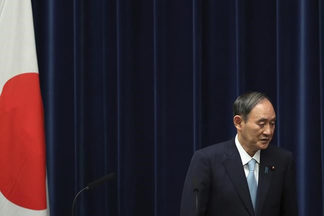 FILE - In this Sept. 9, 2021, file photo, Japanese Prime Minister Yoshihide Suga leaves after a news conference at his office in Tokyo. Japan's governing party will vote Wednesday, Sept. 29, 2021 to pick its new leader who is presumed next prime minister with crucial tasks such as addressing a pandemic-hit economy and ensuring strong alliance with Washington amid growing security risks from China and North Korea.(Kim Kyung-Hoon/Pool Photo via AP, File)