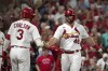 St. Louis Cardinals' Paul Goldschmidt (46) is congratulated by teammate Dylan Carlson (3) after scoring during the fifth inning of a baseball game against the Milwaukee Brewers Tuesday, Sept. 28, 2021, in St. Louis. (AP Photo/Jeff Roberson)