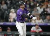 Colorado Rockies' Trevor Story follows the flight of his solo home run off Washington Nationals starting pitcher Patrick Corbin in the fifth inning of a baseball game Tuesday, Sept. 28, 2021, in Denver. (AP Photo/David Zalubowski)