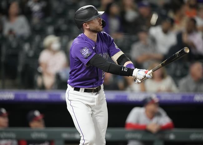 Colorado Rockies' Trevor Story follows the flight of his solo home run off Washington Nationals starting pitcher Patrick Corbin in the fifth inning of a baseball game Tuesday, Sept. 28, 2021, in Denver. (AP Photo/David Zalubowski)