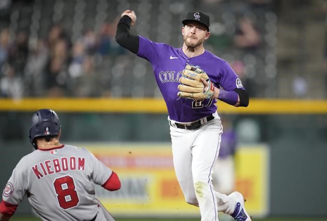Colorado Rockies shortstop Trevor Story, right, forces out Washington Nationals' Carter Kieboom at second base on the front end of a double play hit into by Luis Garcia to end the ninth inning of a baseball game Tuesday, Sept. 28, 2021, in Denver. The Rockies won 3-1. (AP Photo/David Zalubowski)