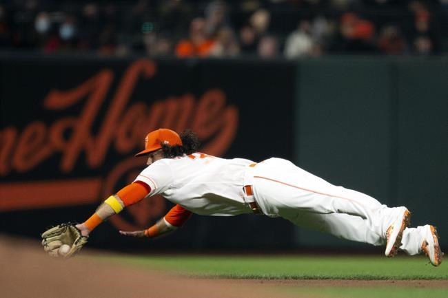 San Francisco Giants shortstop Brandon Crawford (35) makes a diving stop of Arizona Diamondbacks' Kole Calhoun's infield single during the fourth inning of a baseball game, Tuesday, Sept. 28, 2021, in San Francisco. (AP Photo/D. Ross Cameron)