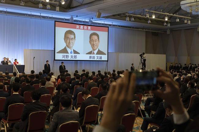 The pictures of Liberal Democrat Party leadership candidates Taro Kono, left, and Fumio Kishida are displayed on a screen during the party leadership election in Tokyo Wednesday, Sept. 29, 2021. Japan's governing party vote to pick a new leader entered a second round Wednesday, with the presumed next prime minister facing imminent, crucial tasks such as addressing a pandemic-hit economy and ensuring a strong alliance with Washington amid growing regional security risks. (Carl Court/Pool Photo via AP)
