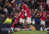 Manchester United's Cristiano Ronaldo, obscured, is surrounded by teammates after scoring the match winning goal during the Champions League Group F soccer match between Manchester United and Villarreal at Old Trafford, Manchester, England, Wednesday, Sept. 29, 2021. (AP Photo/Dave Thompson)