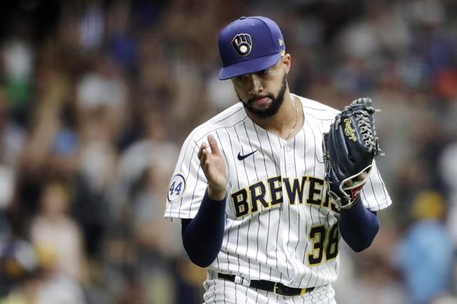FILE - In this Aug. 6, 2021, file photo, Milwaukee Brewers' Devin Williams reacts during the ninth inning of a baseball game against the San Francisco Giants in Milwaukee. Williams fractured his throwing hand Sunday night, Sept. 26, 2021, when he punched a wall after his team celebrated its NL Central title, likely knocking him out for the entire postseason. (AP Photo/Aaron Gash, FIle)