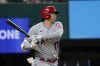 Los Angeles Angels designated hitter Shohei Ohtani follows through on a line out to Texas Rangers shortstop Isiah Kiner-Falefa in the third inning of a baseball game in Arlington, Texas, Tuesday, Sept. 28, 2021. (AP Photo/Tony Gutierrez)
