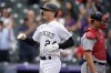 Colorado Rockies' Ryan McMahon, front, crosses home plate after hitting a three-run home run as Washington Nationals catcher Riley Adams looks away in the first inning of a baseball game Wednesday, Sept. 29, 2021, in Denver. (AP Photo/David Zalubowski)