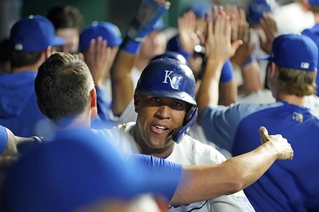 Kansas City Royals' Salvador Perez celebrates in the dugout after hitting a three-run home run during the first inning of a baseball game against the Cleveland Indians Wednesday, Sept. 29, 2021, in Kansas City, Mo. Perez's homer tied Jorge Soler for the Royals' most home runs in a season at 48. (AP Photo/Charlie Riedel)