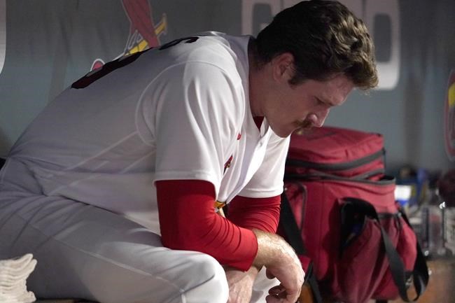 St. Louis Cardinals starting pitcher Miles Mikolas sits in the dugout after being removed during the sixth inning of a baseball game against the Milwaukee Brewers Wednesday, Sept. 29, 2021, in St. Louis. (AP Photo/Jeff Roberson)