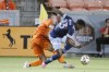 Houston Dynamo defender Sam Junqua, left, and Vancouver Whitecaps defender Javain Brown, right, tangle up as they battle to control the ball during the first half of an MLS soccer match Wednesday, Sept. 29, 2021, in Houston. (AP Photo/Michael Wyke)