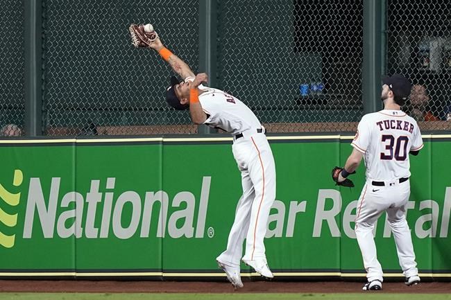 Houston Astros center fielder Jose Siri, left, attempts to catch a fly ball by Tampa Bay Rays' Brett Phillips as right fielder Kyle Tucker (30) looks on during the second inning of a baseball game Wednesday, Sept. 29, 2021, in Houston. Siri was charged with a fielding error which allowed Phillips to reach third base. (AP Photo/David J. Phillip)