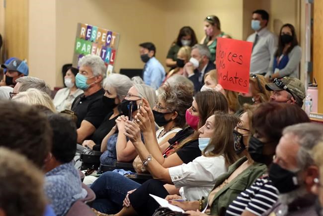 FILE — In this Tuesday, Aug. 17, 2021 file photo, community members gather inside the Dr. Karen M. Trujillo Administration Complex to give public comment against masking policy at a Las Cruces Public Schools board meeting in Las Cruces, N.M. The nation's school boards are asking President Joe Biden for federal assistance to investigate and stop a growing number of threats made against their members, on Thursday, Sept. 30. (Miranda Cyr/The Las Cruces Sun News via AP, File)