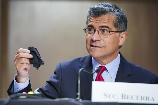 Health and Human Services Secretary Xavier Becerra holds a mask as he testifies during a Senate Health, Education, Labor, and Pensions Committee hearing to discuss reopening schools during the COVID-19 pandemic on Thursday, Sept. 30, 2021, at Capitol Hill in Washington. (Greg Nash/Pool via AP)
