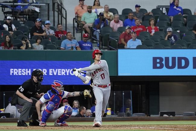 Umpire John Bacon and Texas Rangers catcher Jonah Heim look on as Los Angeles Angels' Shohei Ohtani (17) strikes out in the fourth inning of a baseball game in Arlington, Texas, Thursday, Sept. 30, 2021. (AP Photo/Tony Gutierrez)