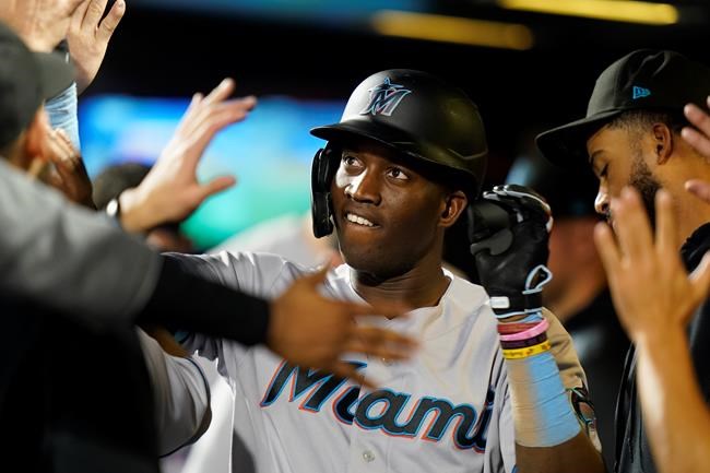 Miami Marlins' Jesus Sanchez celebrates with teammates after hitting a home run during the second inning in the second baseball game of a doubleheader against the New York Mets Tuesday, Sept. 28, 2021, in New York. (AP Photo/Frank Franklin II)