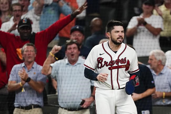 Atlanta Braves' Travis d'Arnaud (16) reacts after scoring on Atlanta Braves Dansby Swanson (7) double the fourth inning of a baseball game against the Philadelphia Phillies Thursday, Sept. 30, 2021, in Atlanta. (AP Photo/John Bazemore)