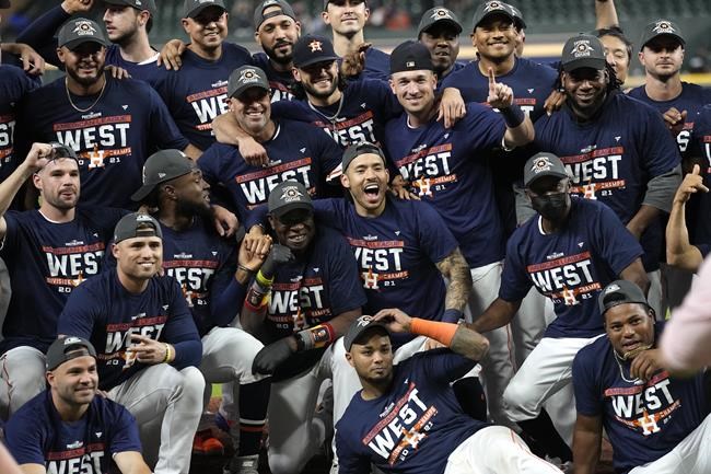 The Houston Astros celebrate after beating the Tampa Bay Rays in a baseball game to win the American League West Thursday, Sept. 30, 2021, in Houston. The Astros beat the Rays 3-2. (AP Photo/David J. Phillip)