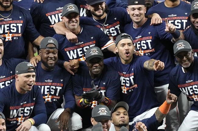 The Houston Astros celebrate after beating the Tampa Bay Rays in a baseball game to win the American League West Thursday, Sept. 30, 2021, in Houston. The Astros beat the Rays 3-2. (AP Photo/David J. Phillip)