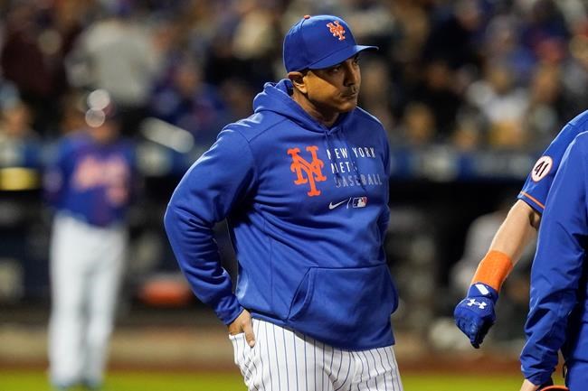 New York Mets manager Luis Rojas checks on Jeff McNeil after he was hit by a pitch during the fourth inning of a baseball game against the Miami Marlins, Thursday, Sept. 30, 2021, in New York. (AP Photo/Frank Franklin II)