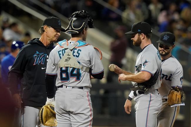 Miami Marlins manager Don Mattingly, left, takes the ball from starting pitcher Sean Guenther during the fourth inning of a baseball game against the New York Mets, Thursday, Sept. 30, 2021, in New York. (AP Photo/Frank Franklin II)