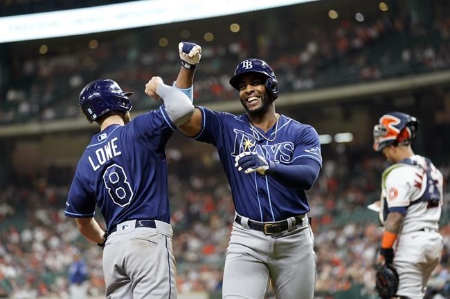 Tampa Bay Rays' Yandy Diaz, right, celebrates with Brandon Lowe (8) after both scored on Diaz's home run against the Houston Astros during the first inning of a baseball game Tuesday, Sept. 28, 2021, in Houston. (AP Photo/David J. Phillip)
